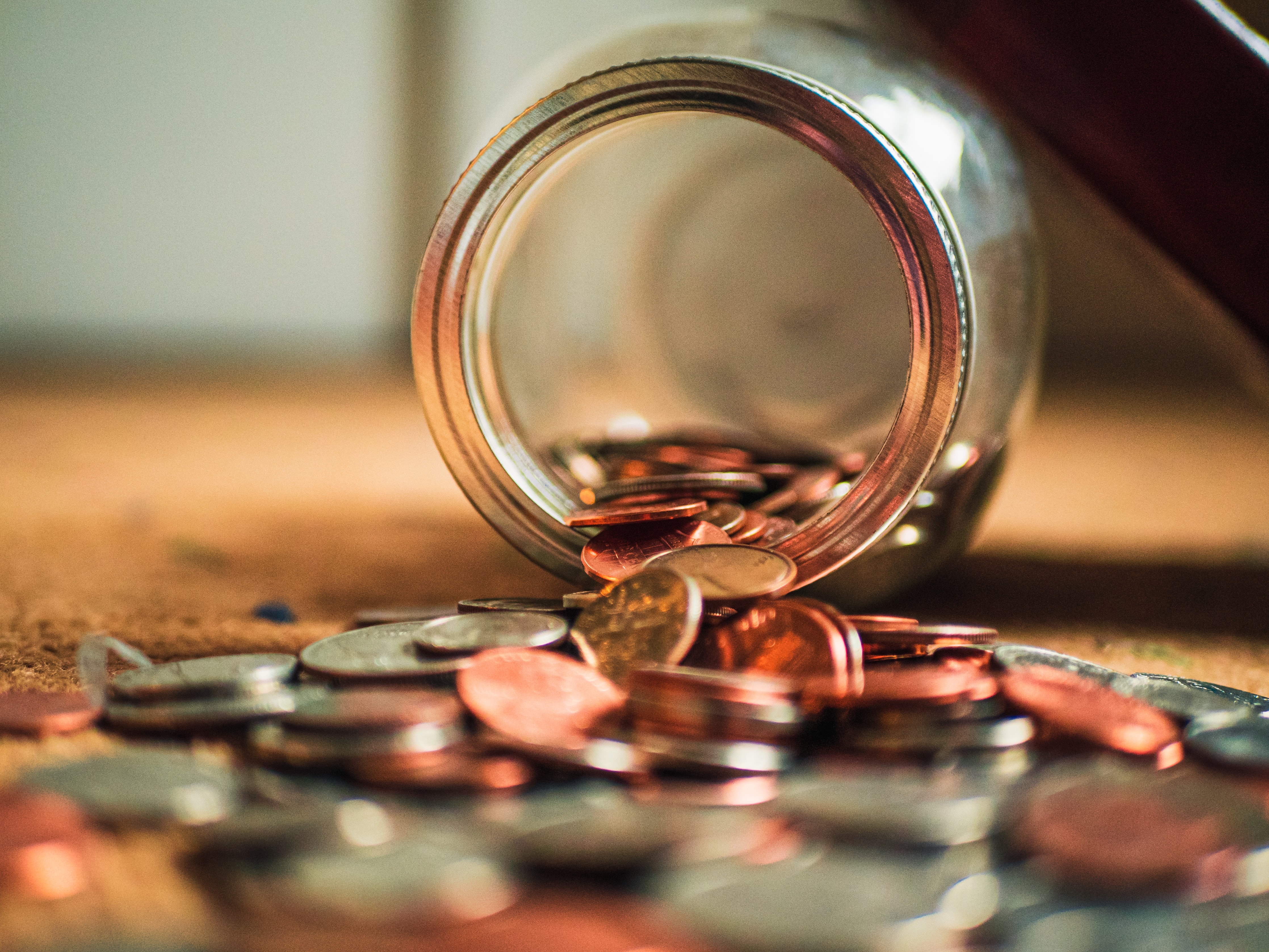 Jar of Coins Spilling on Table