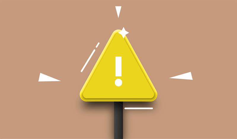 Scam Alert A yellow triangle sign with a white exclamation mark