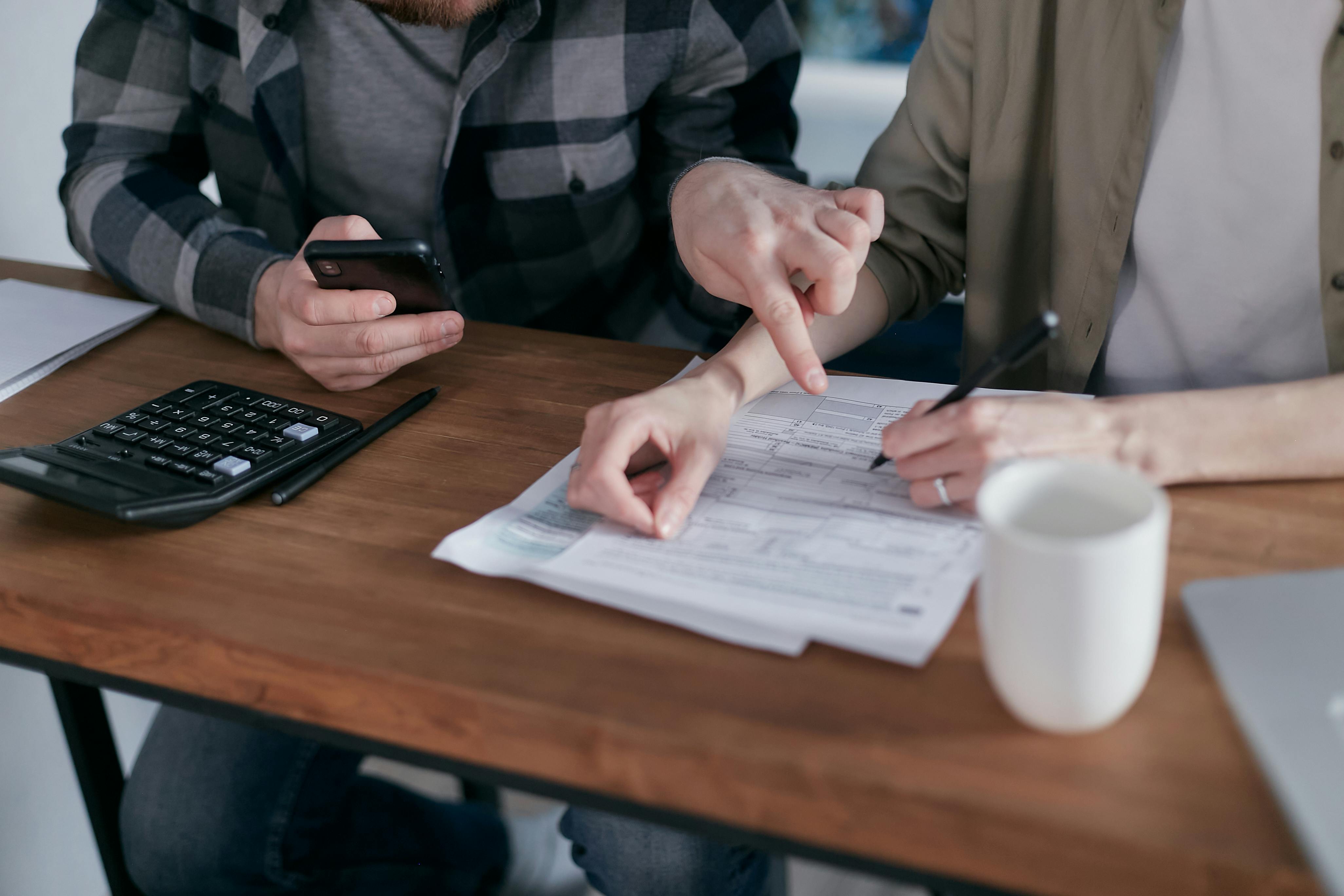 Couple looking at papers and a calculator