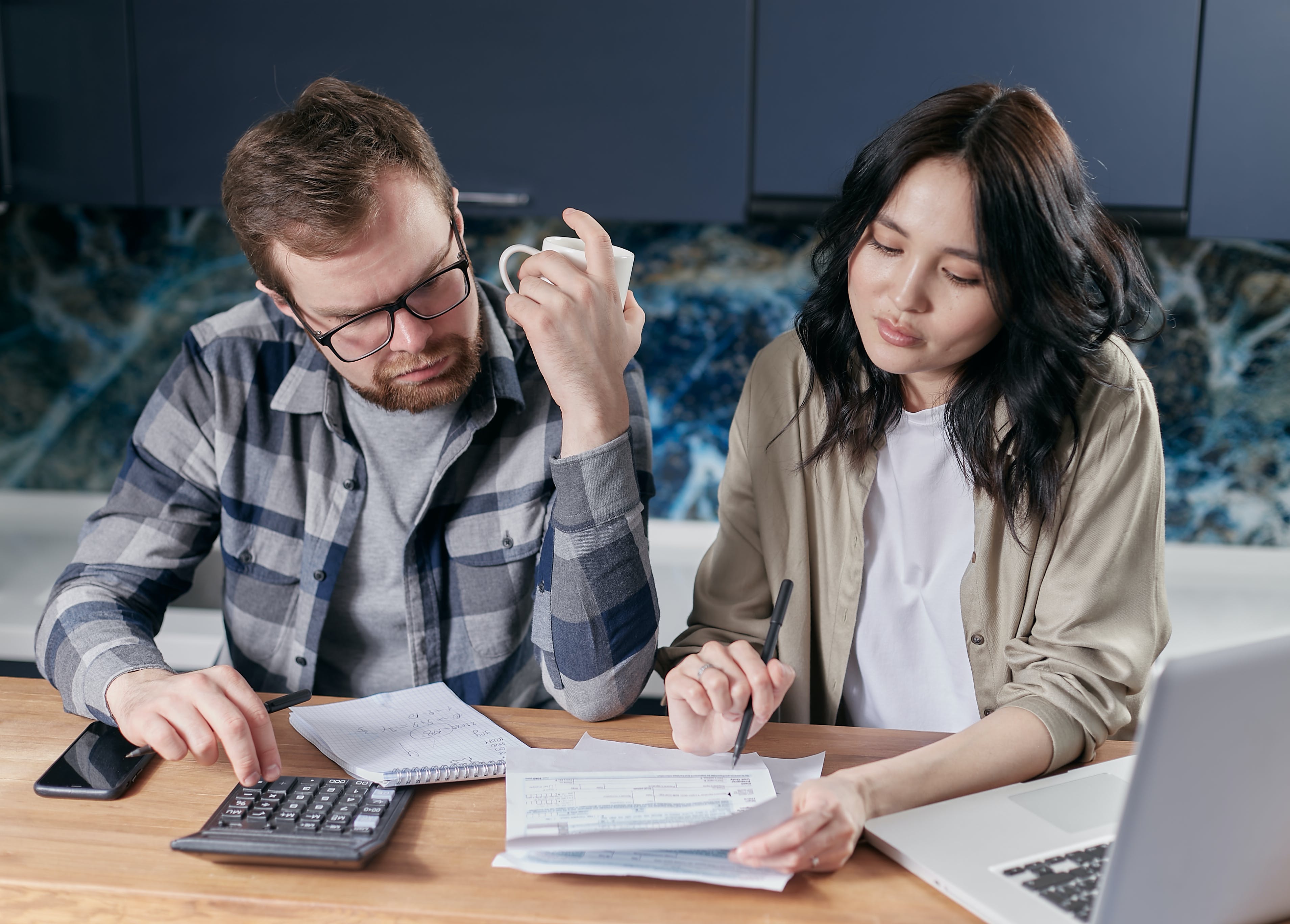 Couple looking at papers and a calculator