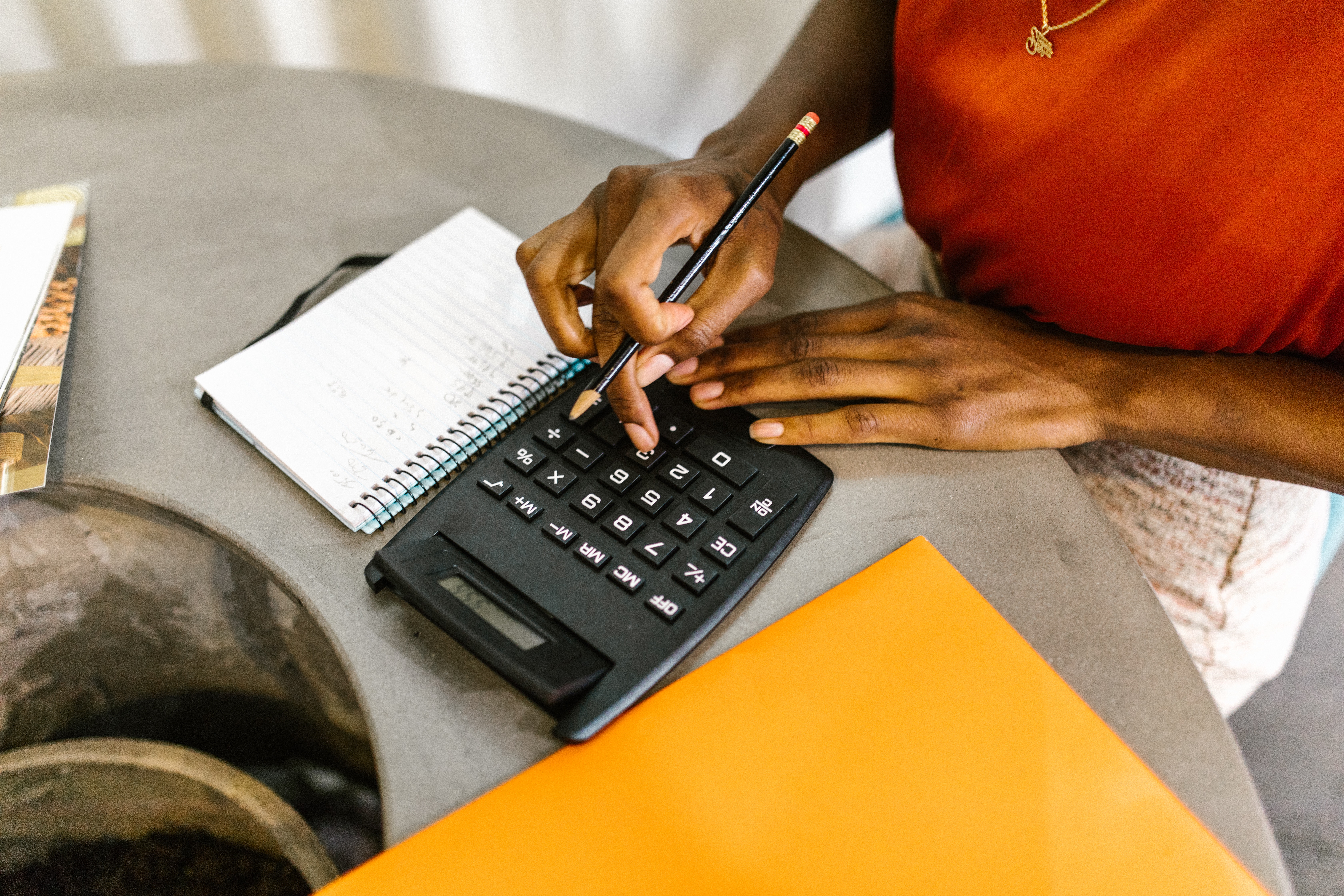 Woman with Calculator, Pencil, and Notebook