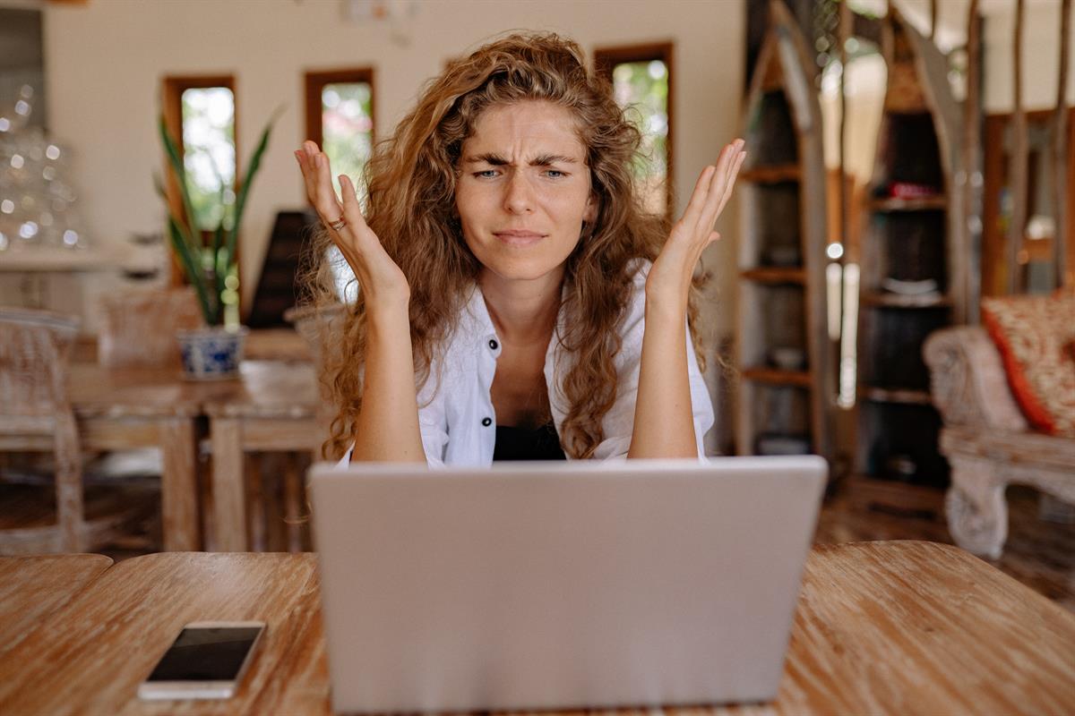 How To Protect Yourself From Identity Theft Confused Woman Sitting in front of Computer
