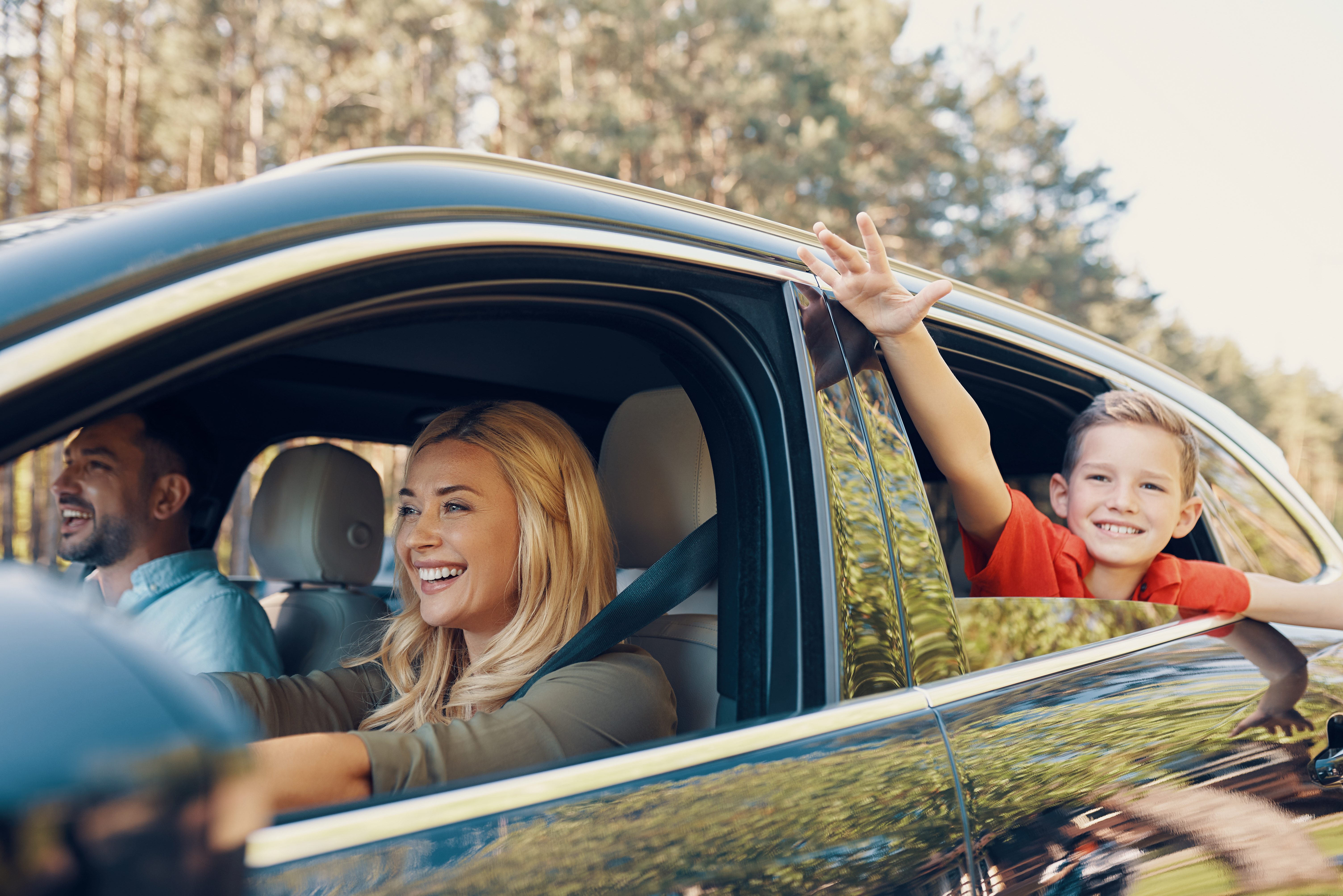 Happy Family in Car with Windows Rolled Down