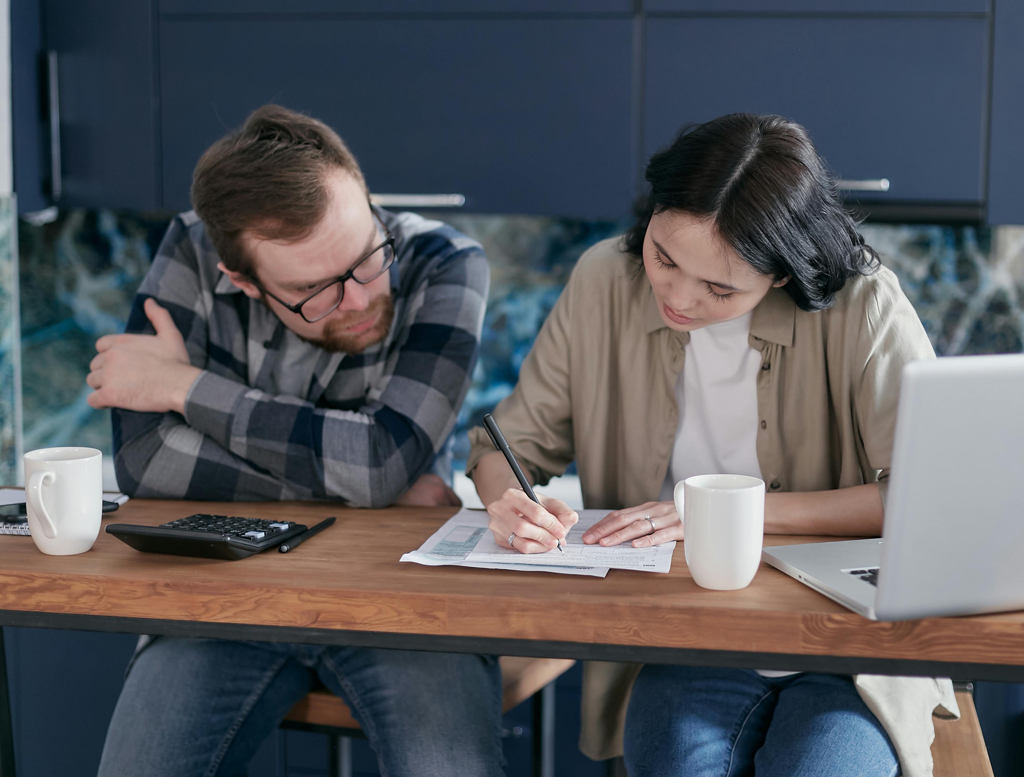 Insurance Claims Couple Filling Out Forms