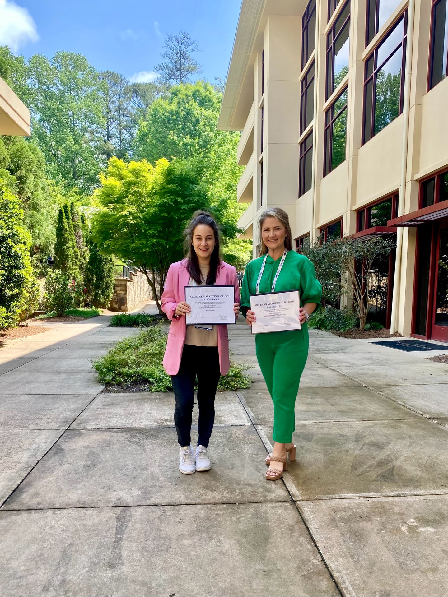 Lauren Lee and Allison Ryan holding Certificates from Bank Marketing School
